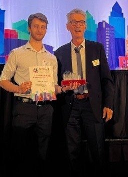 Alexander Rogers receives the award for "Practical Use of Simulation Technology" from NAFEMS' Manfred Zehn, at the 2023 NAFEMS World Congress.
