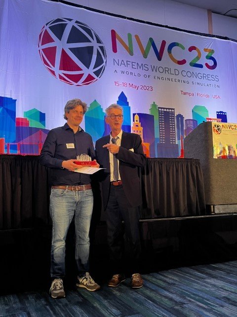 Malte Niehoff receives the award for Best Academic Paper at the NAFEMS World Congress 2023, from NAFEMS vice-chair, Manfred Zehn.